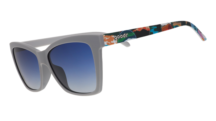 Gray sunglasses with blue gradient lenses and colorful National Park Foundation artwork on the temples.