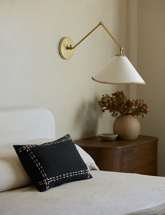 #style::black-lumbar | Accord Black Linen Lumbar Pillow by Elan Byrd styled on a bed.