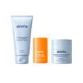 Skinfix Balancing Soft-Foam Clay Cleanser (148 mL | 5 fl.oz.), Brighten + Firm 15% Vitamin C Serum (30 mL | 1 fl. oz.), and Barrier Balancing Water Cream (50 mL | 1.7oz), on a transparent background.