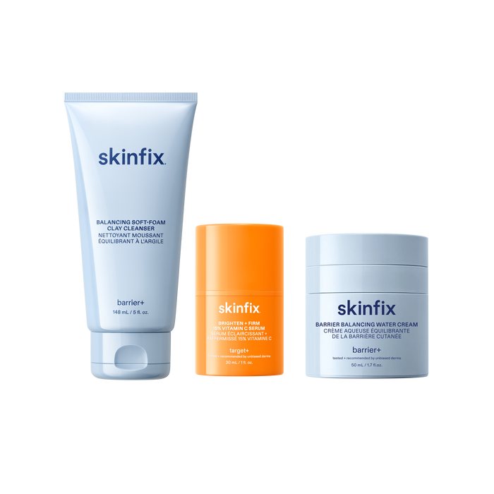 Skinfix Balancing Soft-Foam Clay Cleanser (148 mL | 5 fl.oz.), Brighten + Firm 15% Vitamin C Serum (30 mL | 1 fl. oz.), and Barrier Balancing Water Cream (50 mL | 1.7oz), on a transparent background.