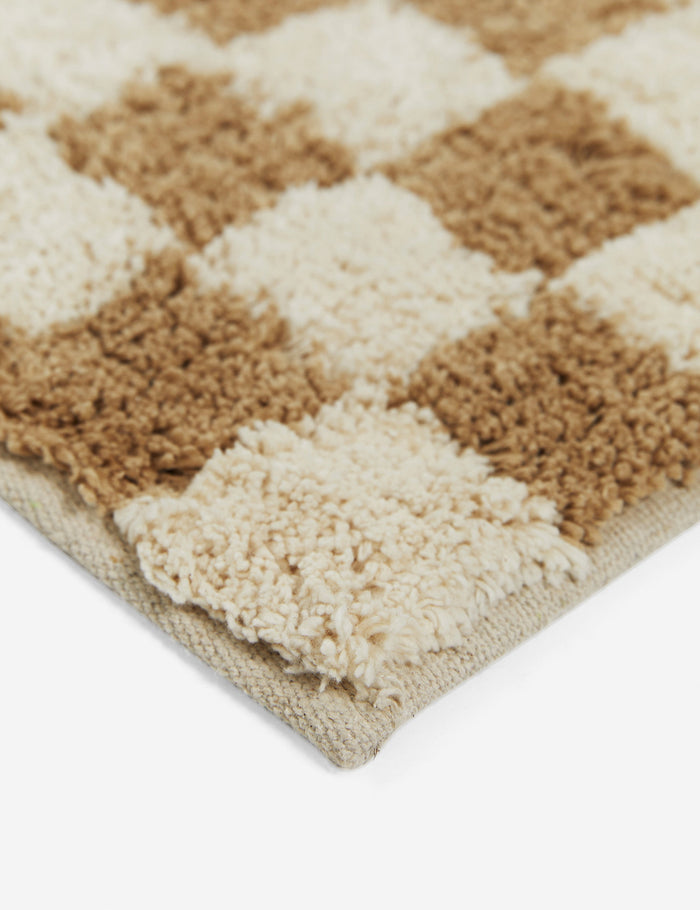 #color::café #size::21--x-34- #size::2--x-5- | Close up corner view of the Two-tone checkerboard bath mat by Sarah Sherman in café brown