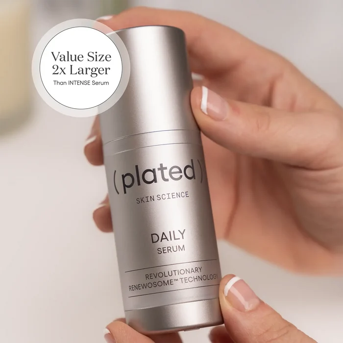 Hands holding a value-size bottle of ( plated ) DAILY Serum, labeled '2x larger than INTENSE Serum'.