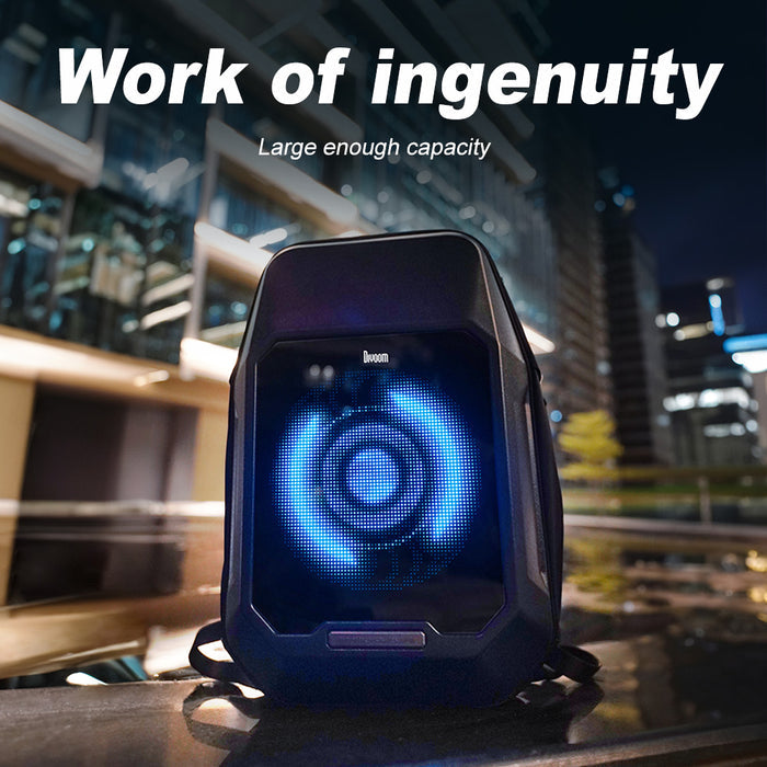 Divoom Cyberbag Pixel Art LED Backpack, black hard-shell backpack with a glowing blue circular pixel display in a modern city at night, smartphone app controlled, urban commute decor