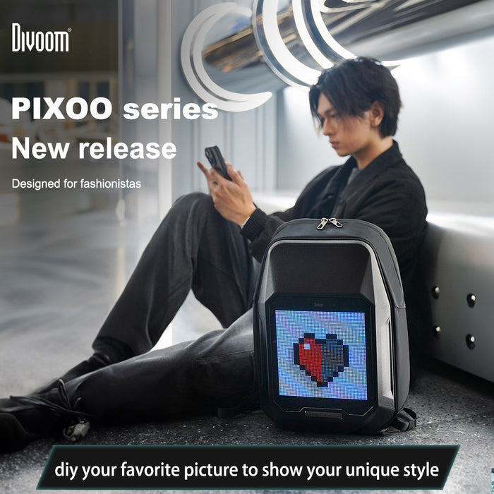 Divoom Cyberbag Pixel Art LED Backpack, black backpack with a red and black pixel heart display beside a seated man using his phone, smartphone app controlled, streetwear lounge decor
