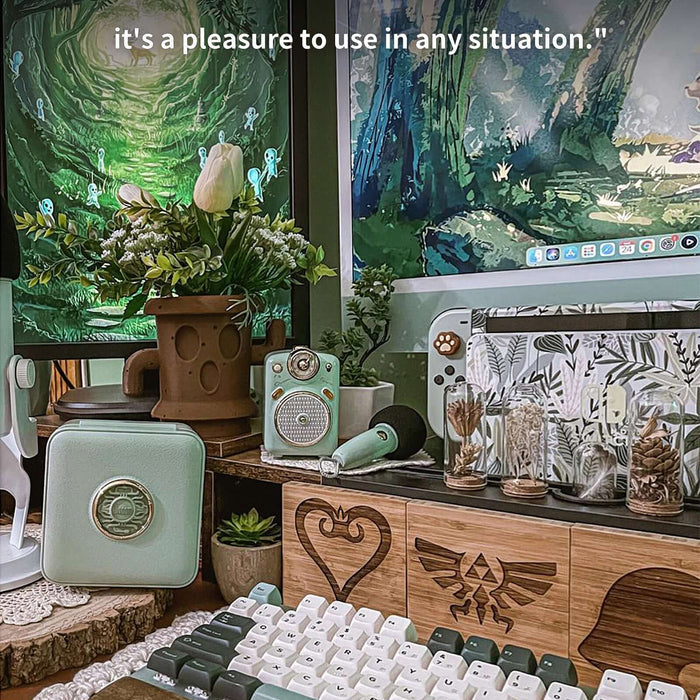 Divoom Fairy-OK Retro Mini Karaoke Speaker, a mint green speaker and microphone on a leafy gaming desk with forest screens, retro karaoke audio for cozy bedroom decor