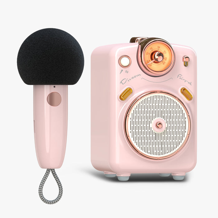 Divoom Fairy-OK Retro Mini Karaoke Speaker, a pink retro speaker with rose gold dial and matching handheld microphone on a plain background, audio playback for home karaoke decor