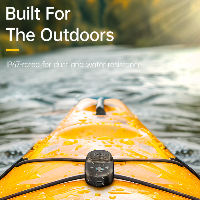 Divoom Itour-S Portable Bluetooth Speaker, compact black speaker splashed with water on a yellow kayak, Bluetooth audio for IP67-rated outdoor paddling decor