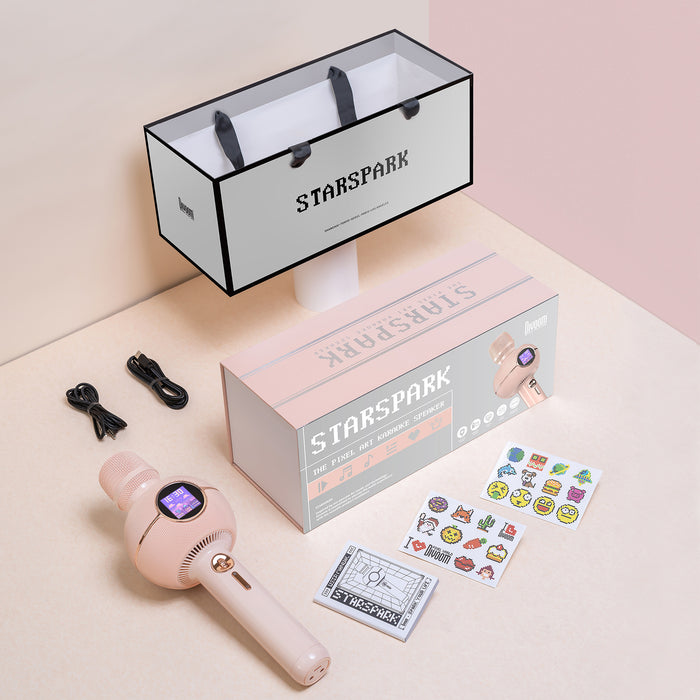 K-StarSpark, pink pixel art karaoke speaker with gift box, shopping bag, cables and sticker sheets on a soft pastel backdrop, audio-ready bedroom decor