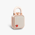Divoom Lovelock Bluetooth Speaker, rose gold padlock-shaped speaker with a glossy shackle handle and red heart accent on a plain white background, portable audio decor