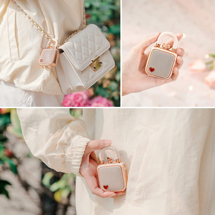 Divoom Lovelock Bluetooth Speaker, rose gold mini lock speaker with a red heart detail, carried on a white quilted chain bag and held in hand, portable audio for chic outdoor decor
