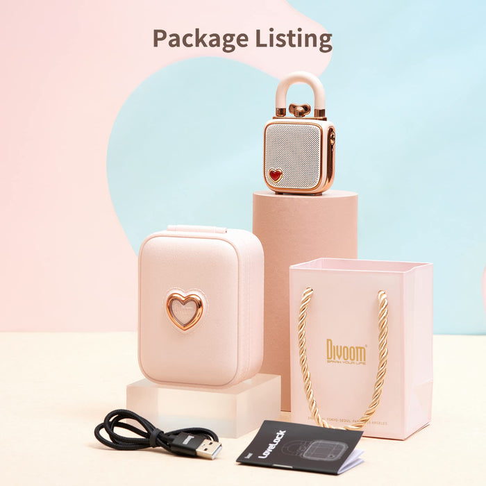 Divoom Lovelock Bluetooth Speaker, rose gold lock-shaped speaker with pink case, gift bag, USB cable and manual on pastel display, bedside audio decor