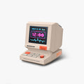 Divoom MiniToo Retro Pixel Bluetooth Speaker, cream retro computer-style speaker with a neon pink digital clock and blue waveform display, audio playback for bedside decor