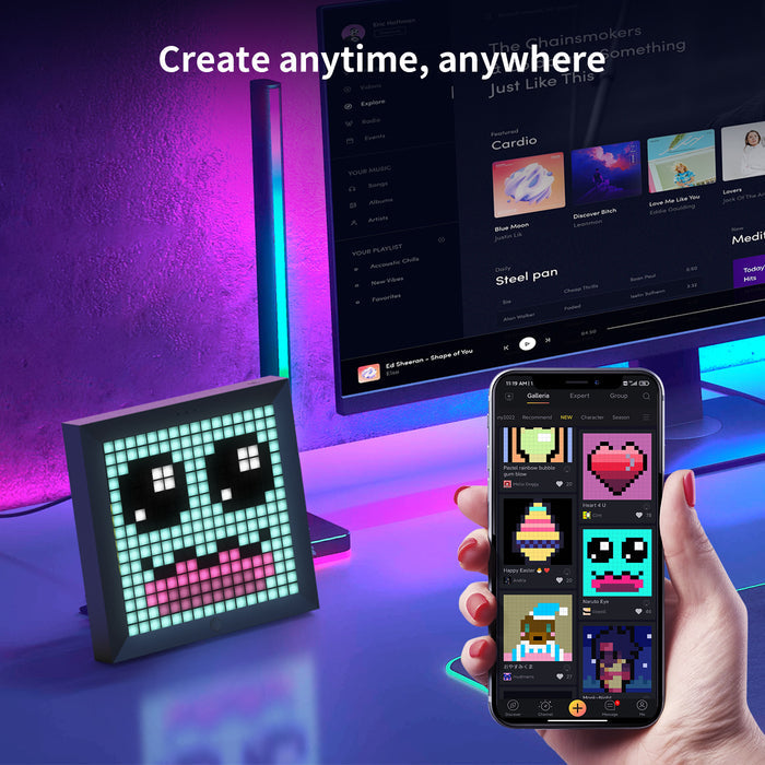 Divoom Pixoo 16x16 pixel art LED display, a cute blue face with big eyes and pink mouth on a neon desk beside a monitor, smartphone app controlled, gaming room decor