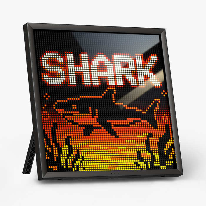Divoom Pixoo64 II 64x64 Pixel Art LED Display Social Media Counter, black framed pixel display with a bright SHARK graphic on a plain background, smartphone app controlled, gaming room decor