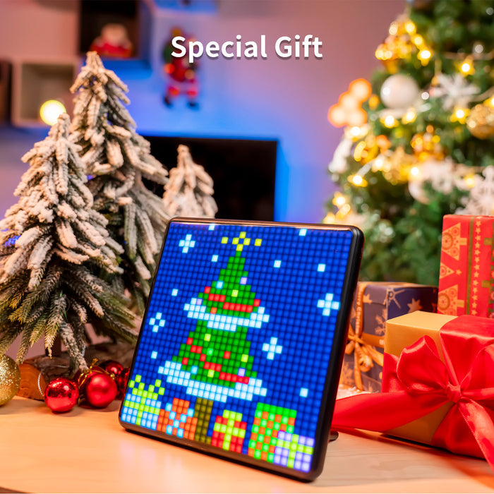 Divoom Pixoo-Max 32 X 32 Pixel Art LED Display, a pixel Christmas tree with snow and gifts beside wrapped presents, smartphone app controlled, holiday living room decor