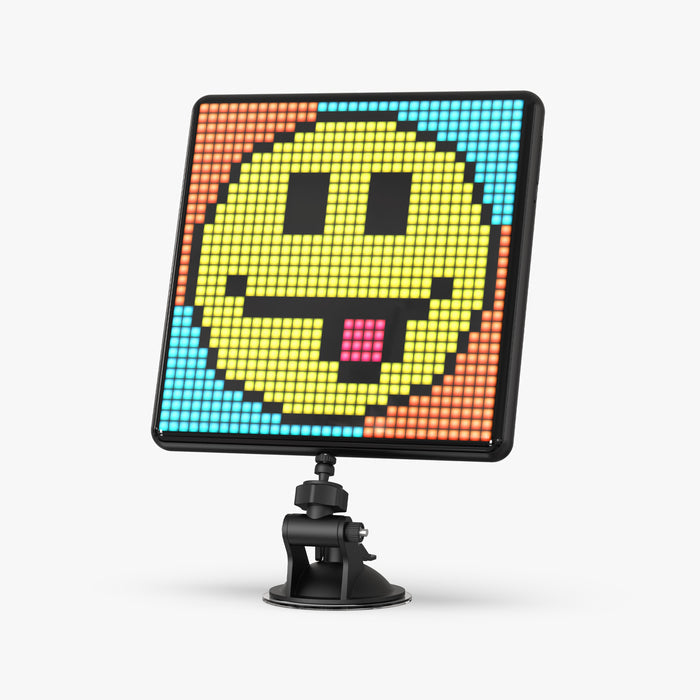 Divoom Pixoo-Max 32 X 32 Pixel Art LED Display, a large yellow pixel smiley face on a blue and orange background on a suction mount, smartphone app controlled, desk decor