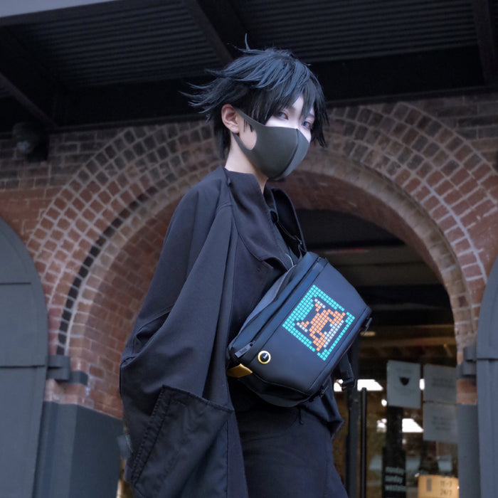 Divoom Sling Bag Pixel Art LED Daypack, an orange pixel dog on a blue screen, worn crossbody with black streetwear, smartphone app controlled, urban fashion decor