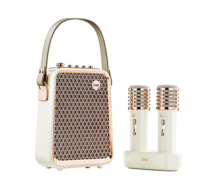 Divoom Songbird-HQ Portable Karaoke Bluetooth Speaker | Home KTV sound set, cream speaker with rose gold grille, top controls, carry handle and two matching wireless microphones on a charging dock, Bluetooth audio for stylish home karaoke party decor