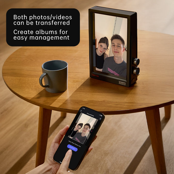 Times Frame Pure, retro black digital photo frame displaying a selfie portrait beside a mug on a wooden table, smartphone app controlled, living room side table decor