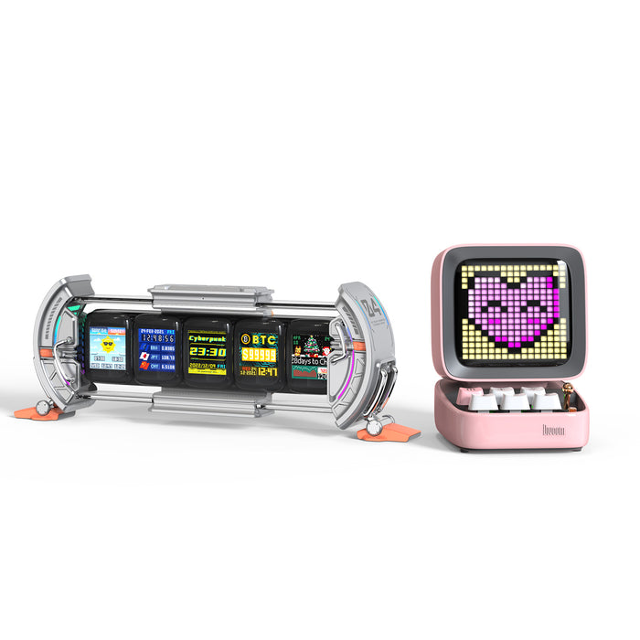 Divoom Times Gate & Ditoo Pro, silver multi-screen cyber clock beside a pink pixel speaker with a heart-eyed cat face, smartphone app controlled, desk setup decor