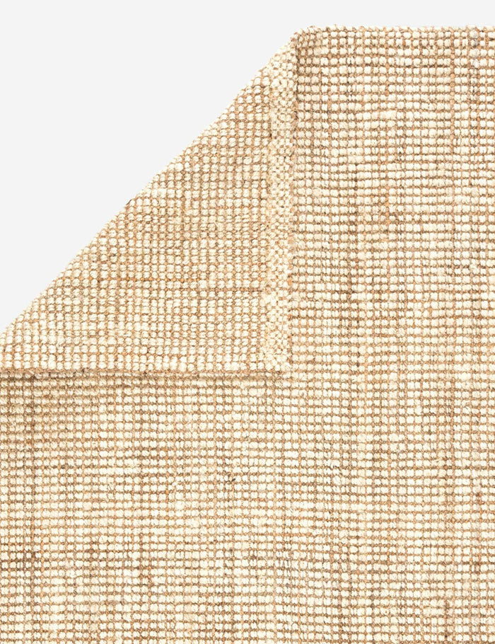 #color::natural #size::2--x-3- #size::3--x-5- #size::5--x-8- #size::8--x-10- #size::9--x-12- #size::10--x-14- #size::2-6--x-9--runner #size::2-6--x-12--runner  #size::12--x-15- #size::4--x-6- | Close-up of the folded over corner of the Harriette scandinavian-inspired rug made of 100% jute