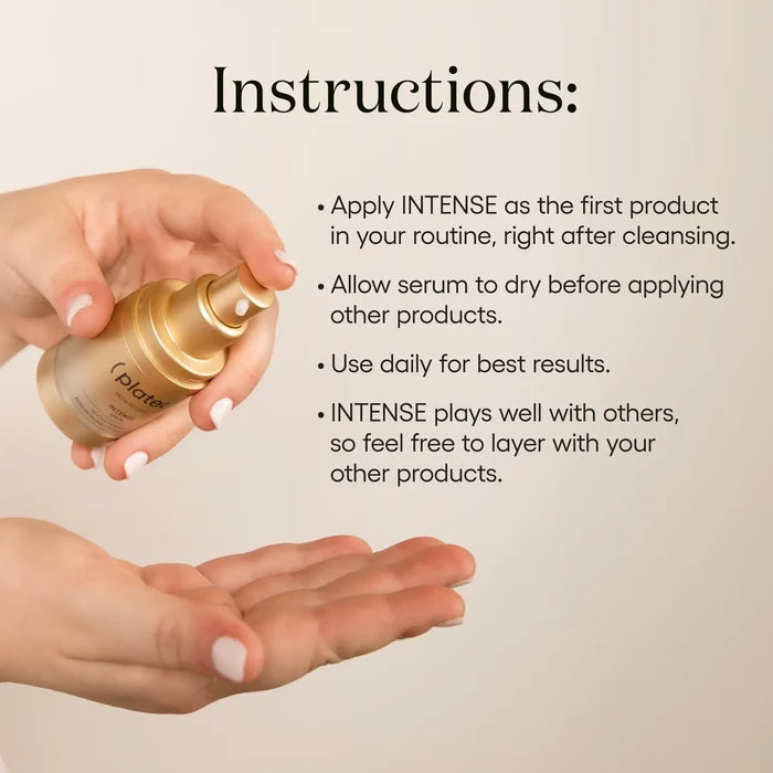 Hand holding ( plated )'s INTENSE Serum bottle with application instructions on a beige background