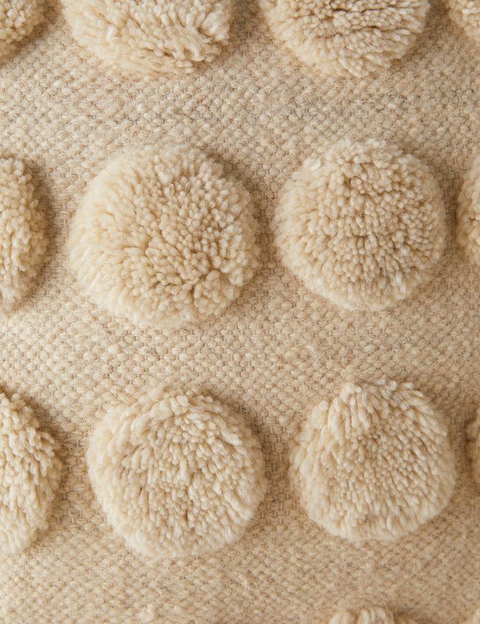 #style::square #style::lumbar | Close up of the tufted dot pattern of the Kohta pillow