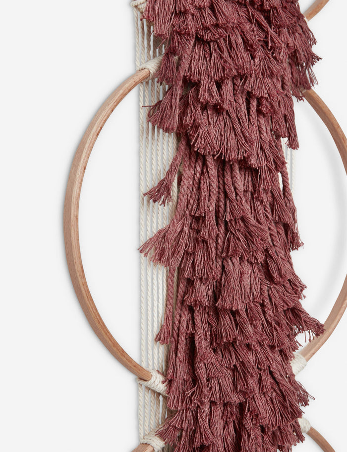 #color::brick | Close-up of the tasseled material on the Studio Nom Lwazi brick red woven Wall Hanging by nom