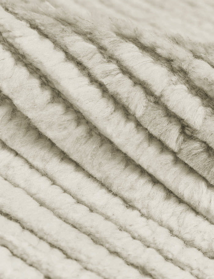 #size::2-6--x-8- #size::6--x-9- #size::8--x-10- #size::9--x-12- #size::10--x-14- #size::12--x-15- | Close-up of the two-toned ribbed fabric on the Nomad neutral-toned geometric floor rug by Élan Byrd