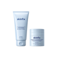 Skinfix Balancing Soft-Foam Clay Cleanser (148 mL / 5 fl. oz.) and Barrier Balancing Water Cream (50 mL / 1.7oz), both in light blue packaging, on a transparent background.