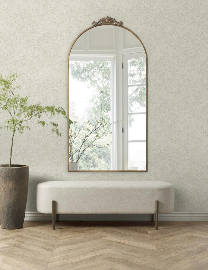 | The parma wallpaper is in a room with chevron floors, a large wall mirror, and a stone planter