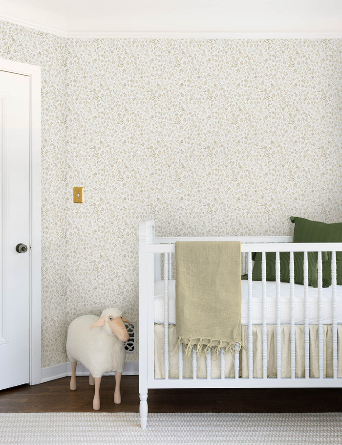 #color::natural | The sommerville natural wallpaper is in a children's room with a sheep toy and a white crib with ivory and blue linens