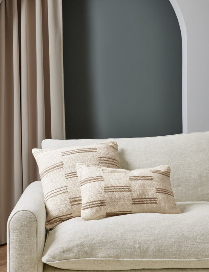 #style::lumbar #style::square | Two Stripe break natural and cream pillows by Sarah Sherman Samuel sit together atop a natural linen sofa in a room with green painted walls