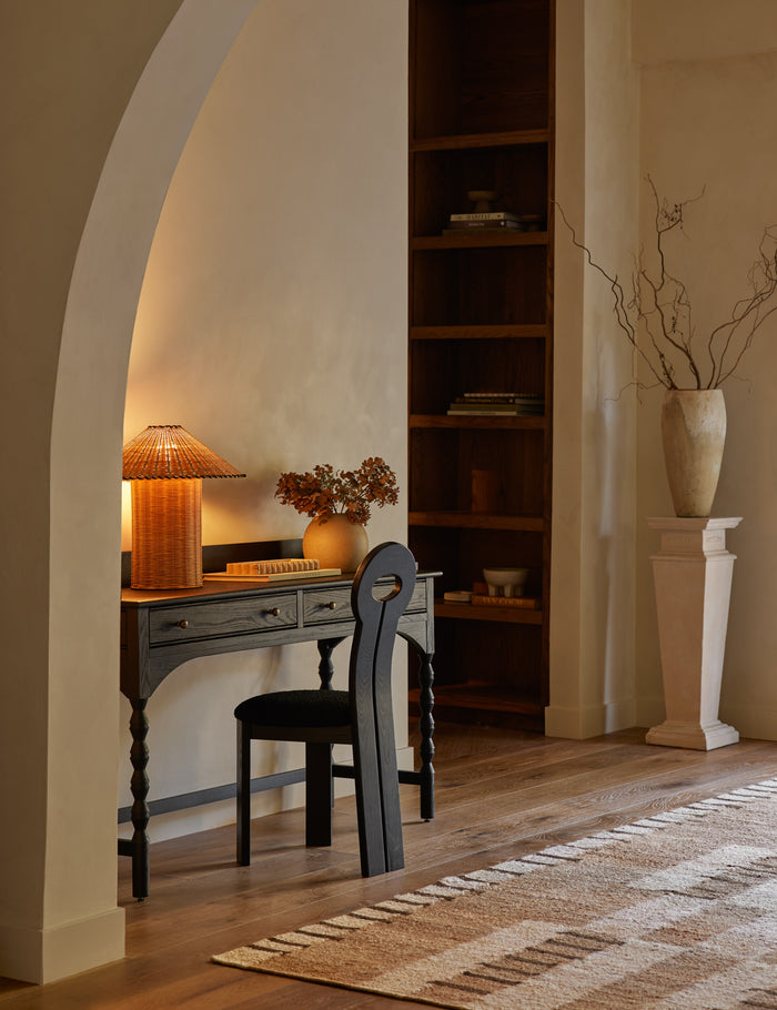 #color::natural | Terrene Woven Rattan Table Lamp by Elan Byrd styled on a desk.