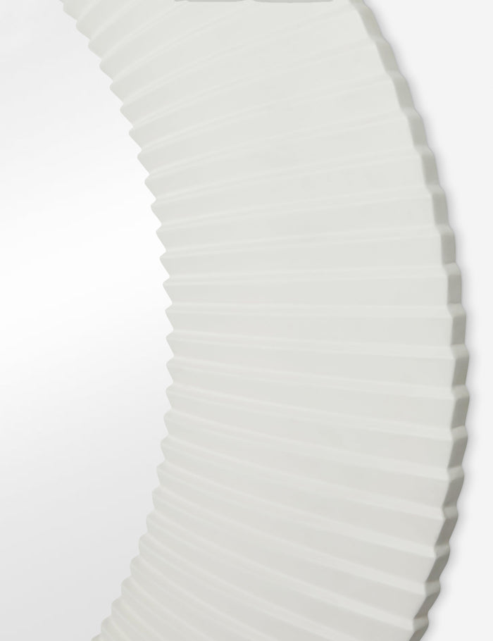 #color::white | Close up of the Whitaker white asymmetrical oval wall mirror.