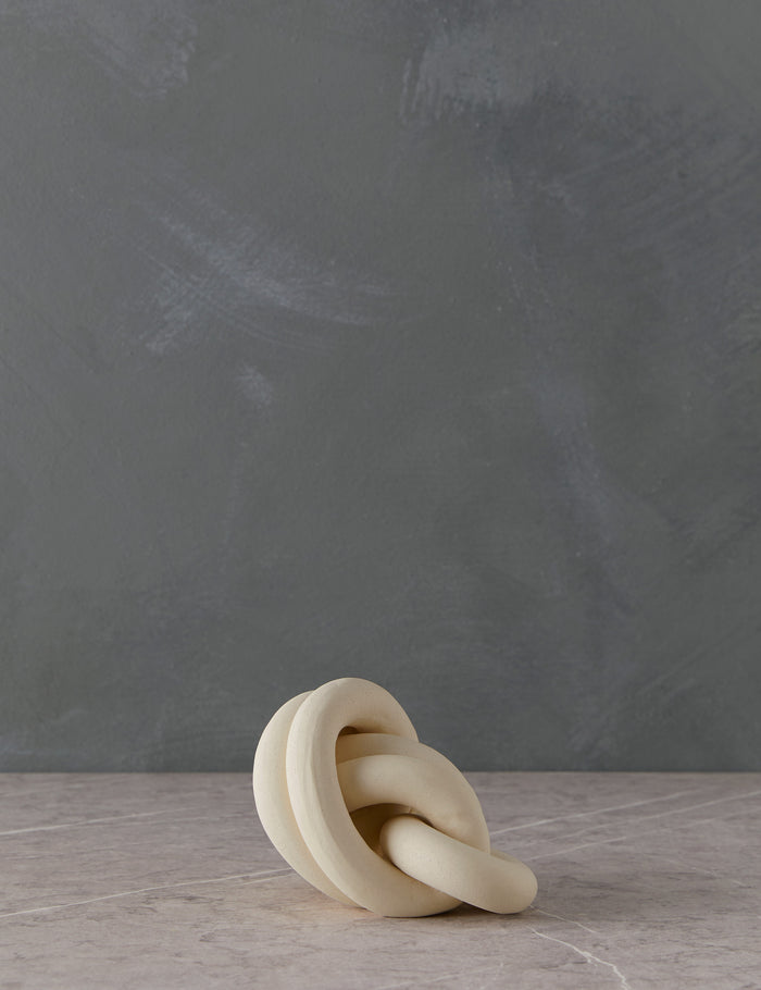 #color::bone | Angled view of the decorative ceramic double coil XL Fist Knot by SIN Ceramics